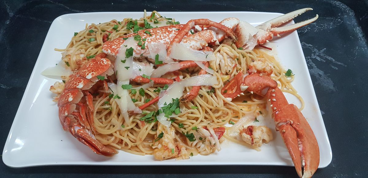 Lobster linguine on a white platter