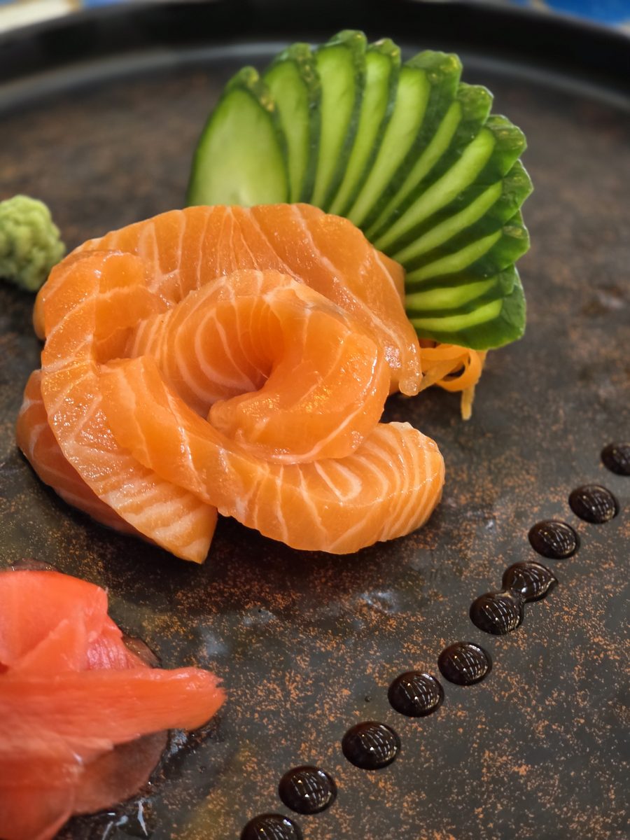 Salmon sashimi arranged as a rose with cucumber